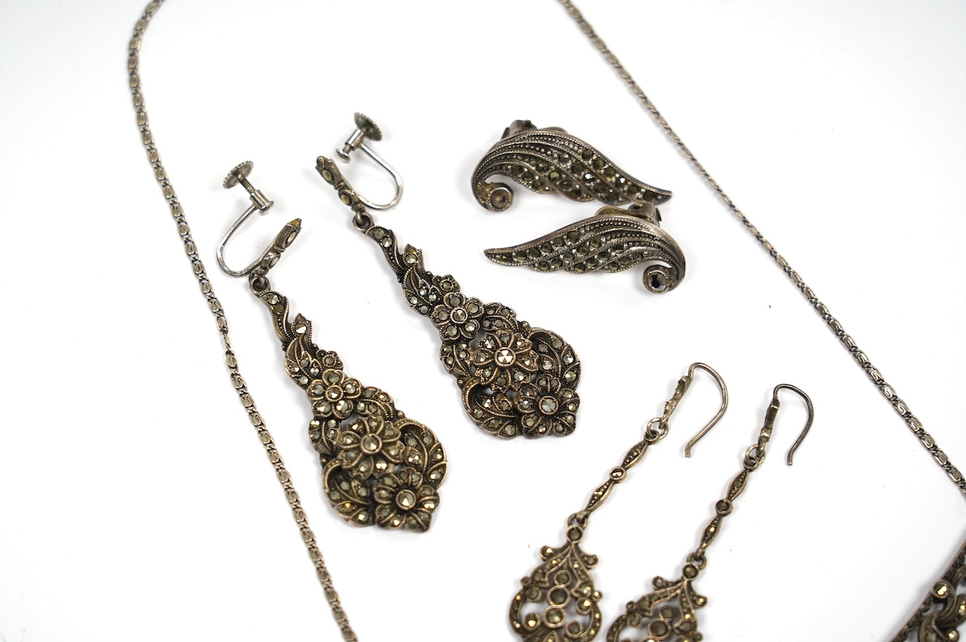 Two pairs of white metal and marcasite earrings, a similar pair of ear clips and a necklace. Condition - poor to fair